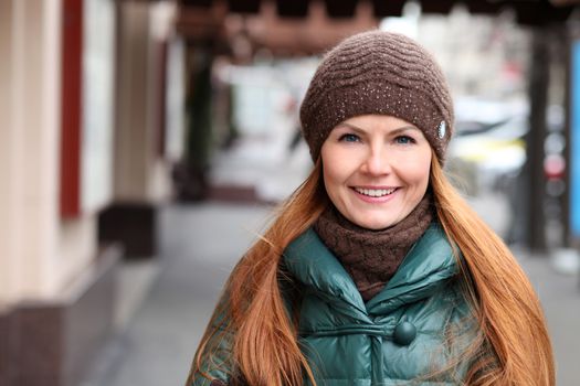 Happy young woman in autumn city