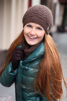 Happy young woman in autumn city