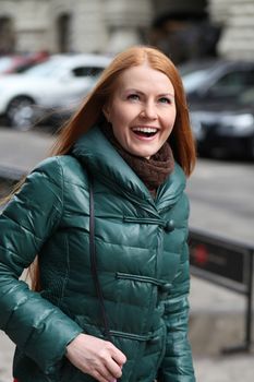 Happy young woman in autumn city