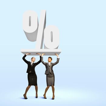 Image of two businesswomen holding percentage symbol above head