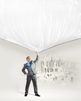 Image of young businessman pulling blank banner from above