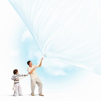 Young happy family pulling blank banner. Place for text