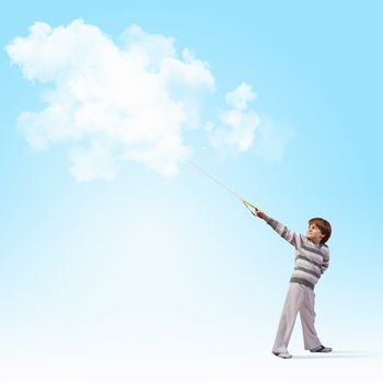 Image of little cute boy catching clouds in sky