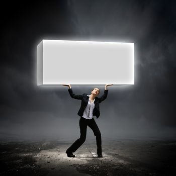 Image of young businesswoman holding burden above head