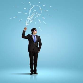 Image of young businessman with light bulb. New idea and inspiration