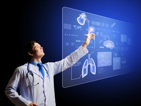 Young male doctor touching icon on media screen