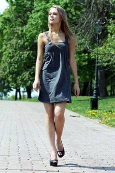 Beautiful young woman walking on the street