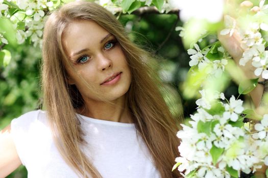 Portrait of beautiful blond in spring blossom