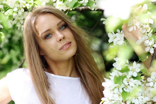 Portrait of beautiful blond in spring blossom