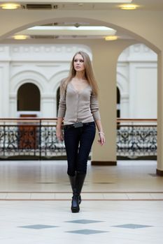 beautiful young woman walking in the shop