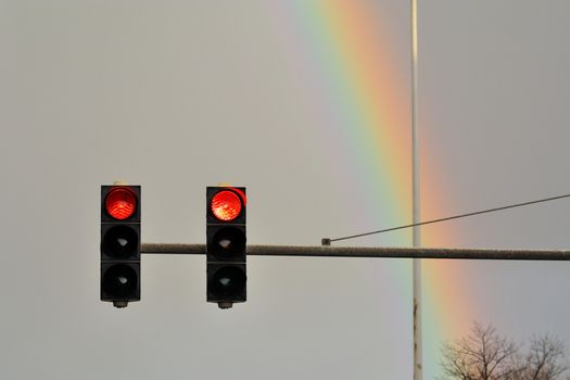 Red lights in front of a rainbow