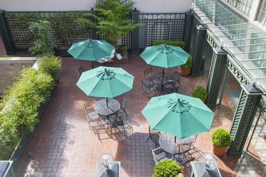 Outdoor Patio Seatings with Tables Chairs and Green Umbrellas