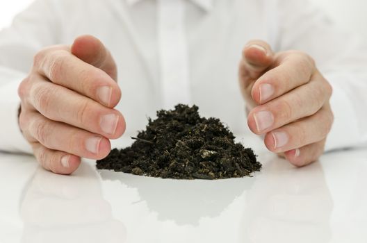 Male hands around pile of soil. Concept of alternative medicine.