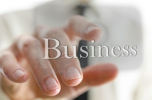 Closeup of businessman hand pressing Business icon on a virtual screen.