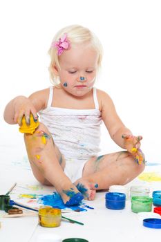 Little girl bedaubed with bright colors