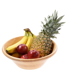 wooden fruit bowl with a pinapple banannas and apples isolated on white background