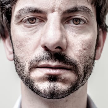 closeup portrait of bearded man on white background