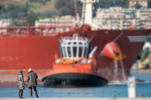 tugs in action with the tanker