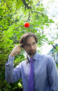 thinking man under the apple in the garden