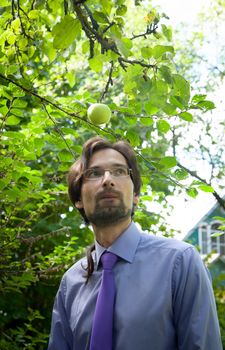 thinking man under the apple in the garden