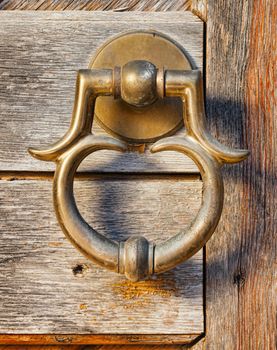  old brass door handle on wooden gate