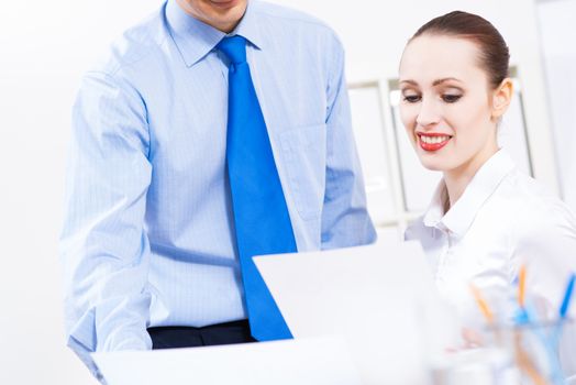 colleagues discuss the reports at a desk in the office, working together in business