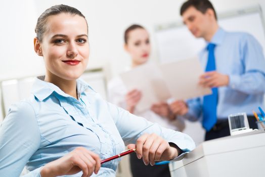 portrait of a business woman in office, smiling and looking into the camera, office work