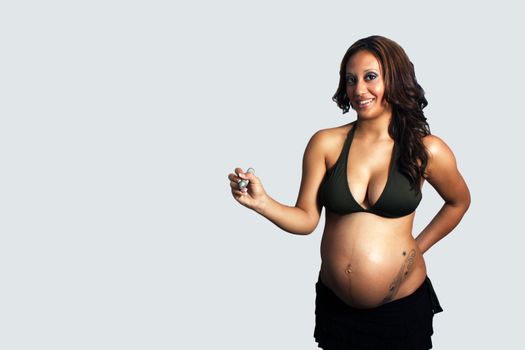 A lovely young multiracial woman, eight months pregnant, holds a heavy marker, allowing you to insert your own text or drawing as if she's writing or drawing it.