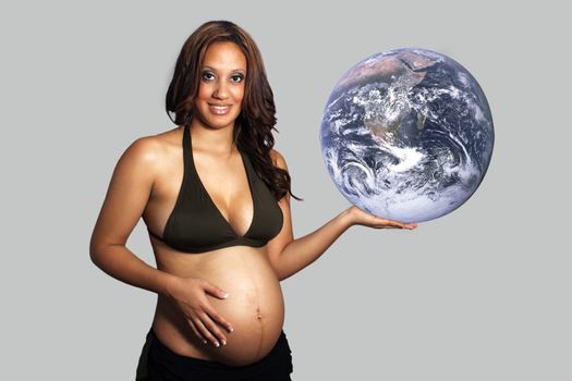 A lovely young pregnant multiracial woman holds the earth in her hand.  (Earth photo courtesy of NASA, public domain.)