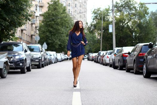 Beautiful young woman walking on the street