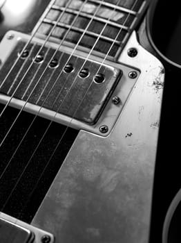 Macro abstract photo of the pickups and strings of an electric guitar. 