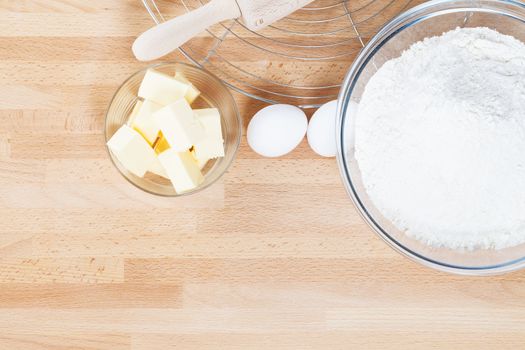 baking ingredients from top on wooden background