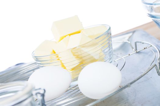 butter on a cooling grid with eggs on a metal tray