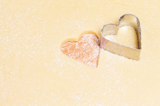 cutting out hearts with a mold from dough