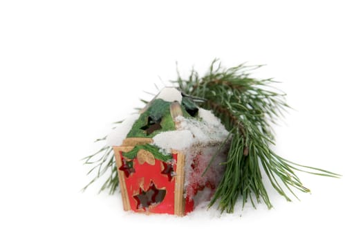 twig of fir and Christmas candle on snow background