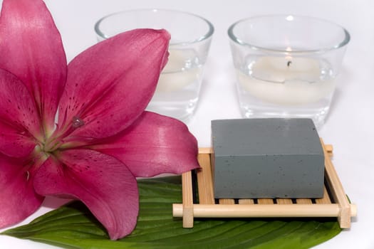 soap with natural ingredients , flowers and candle in glass 