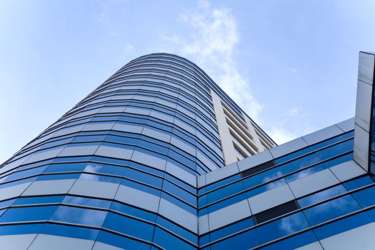 light blue transparent windows of contemporary glass skyscraper in Bangkok, Thailand