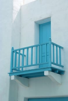 Vintage blue door and terrace on the white wall 