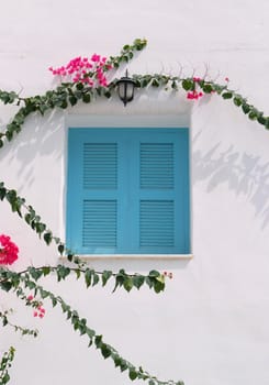 Vintage blue window on the white wall 