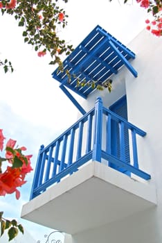 Vintage blue door and terrace Decorative with flowers on the white wall. 