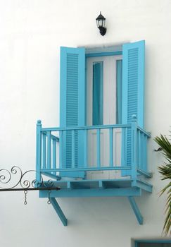 Vintage blue door and terrace on the white wall 