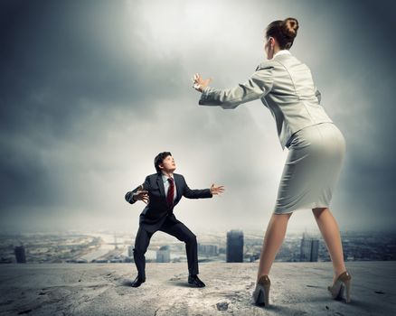 Image of businesspeople arguing and acting as sumo fighters