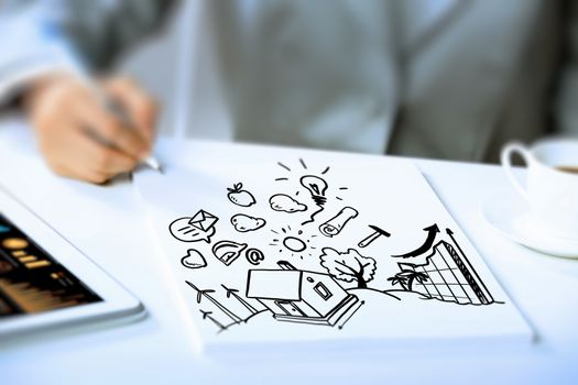 Image of businesswoman sitting at table and drawing sketch