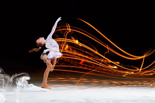 Little girl figure skating at sports arena