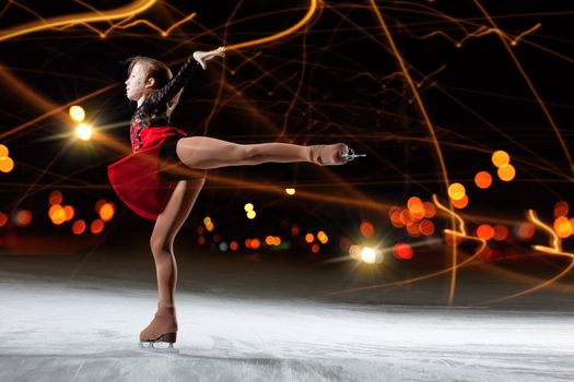 Little girl figure skating at sports arena