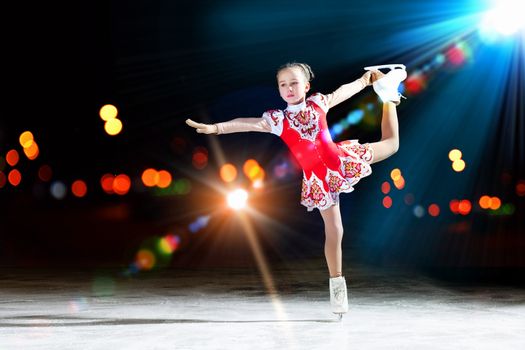 Little girl figure skating at sports arena