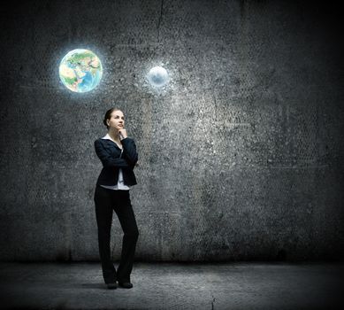 Image of thoughtful businesswoman looking at planet earth
