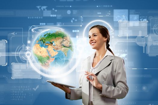 Young businesswoman with tablet pc in hands. Globalization concept. Elements of this image are furnished by NASA