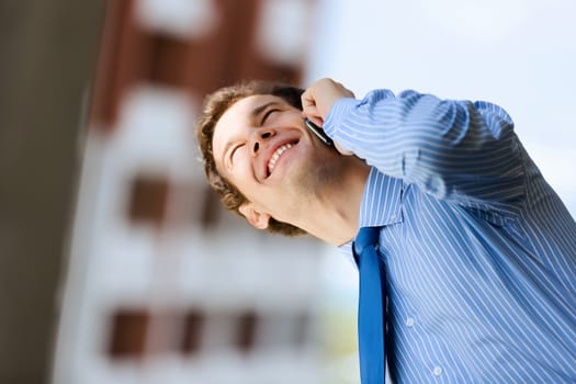 Image of handsome businessman speaking on mobile phone