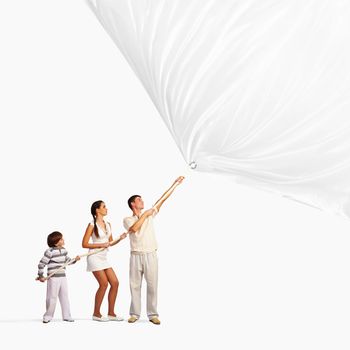 Young family of three pulling blank banner. Place for text